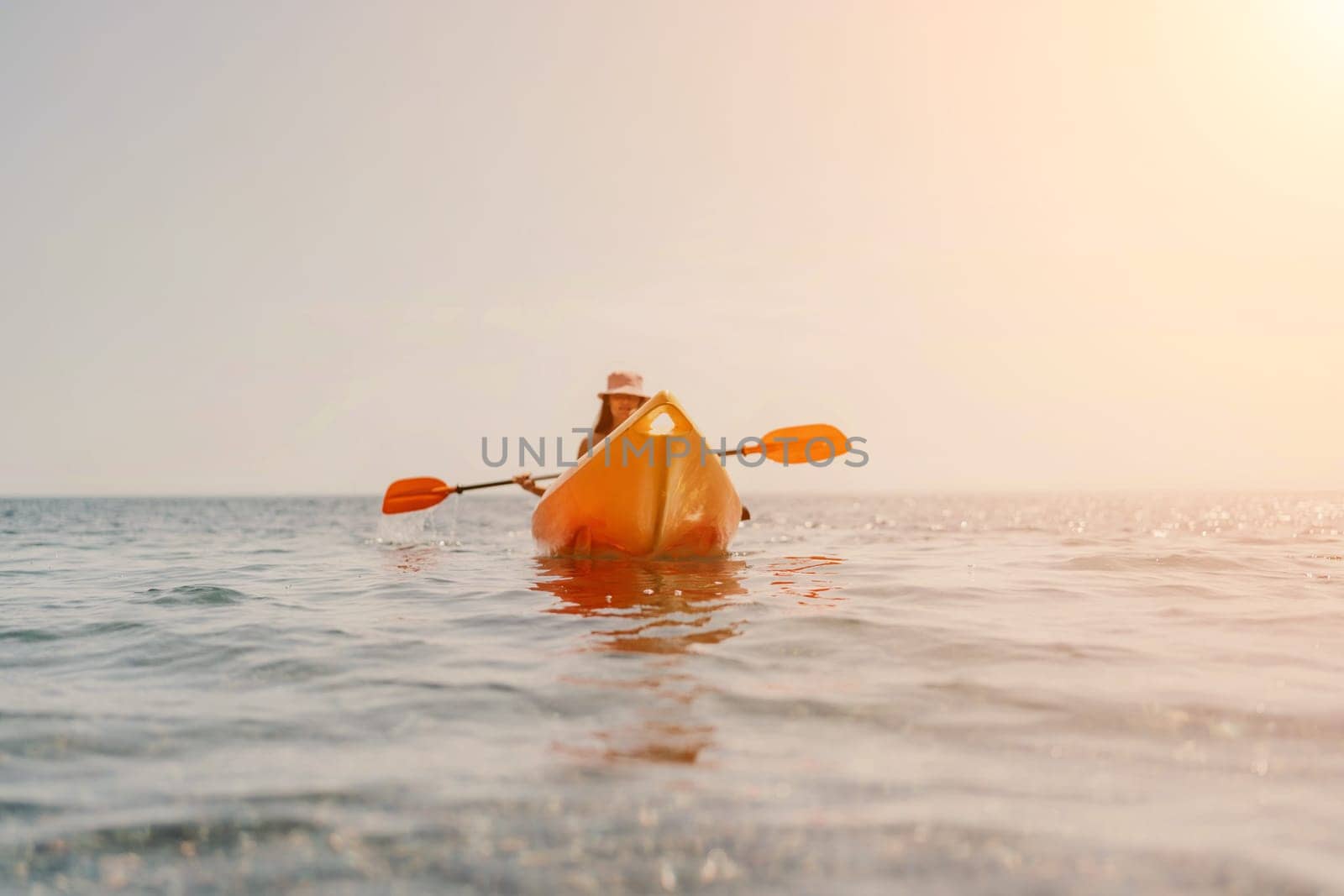 Kayak sea woman. Happy attractive woman with long hair in red swimsuit, swimming on kayak. Summer holiday vacation and travel concept