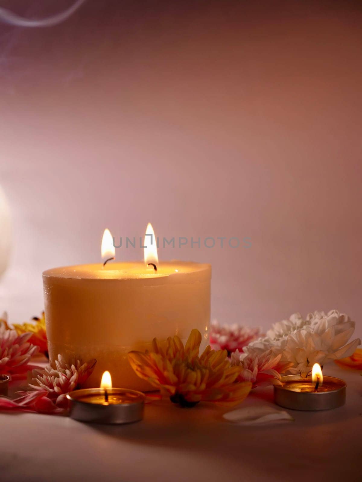 Celebration of Diwali or Deepavali holiday in India with candles and flowers in the evening at night close-up. Hindus celebrate the festival of lights, vertical