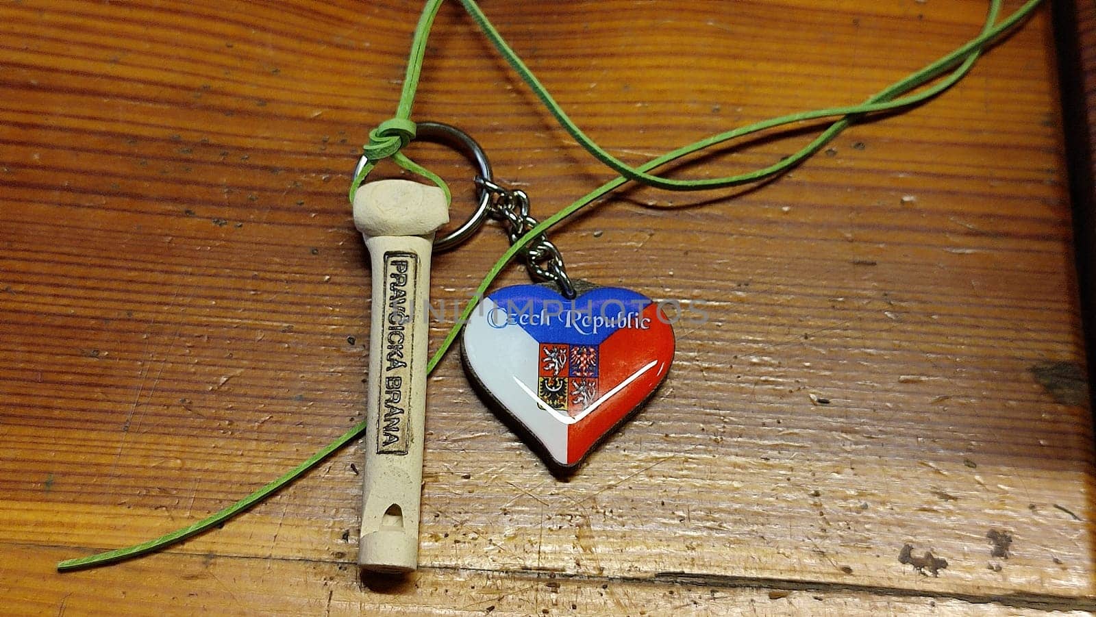 October 17 2024 Hrensko Czech Republic Europe Whistle heart keychain wooden table objects toy. High quality photo