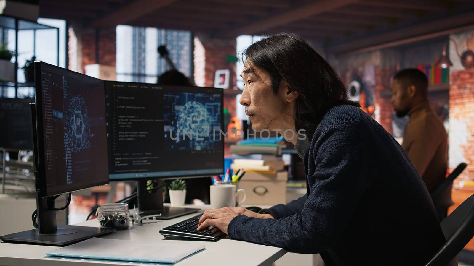 Software engineer in small business workspace using computer to oversee artificial intelligence neural networks. Person in tech startup office using AI machine learning systems on PC, camera A