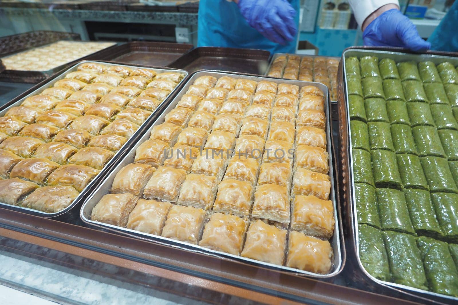 Several trays show a variety of baklava and sweets for sale.