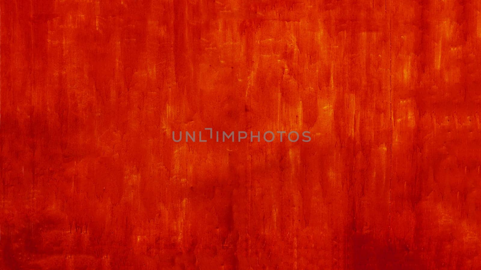 Texture of worn red paint on the wall. Metal plate covered with red paint.