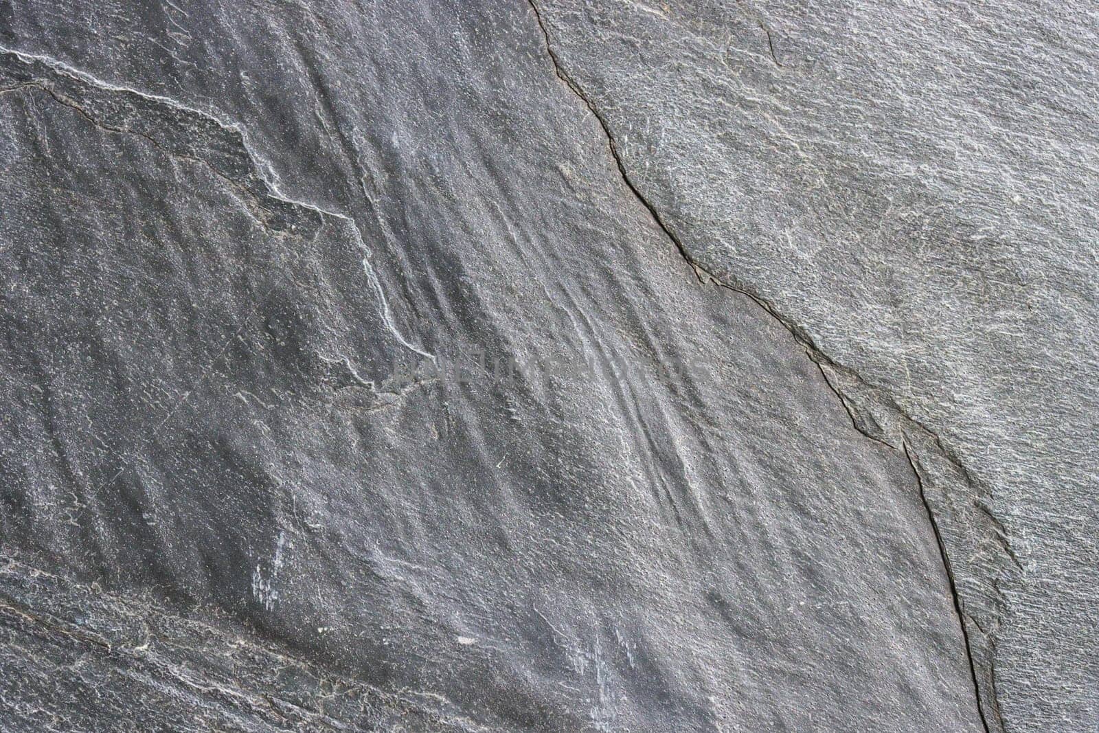 The surface of a granite stone painted gray. Abstract background for design.