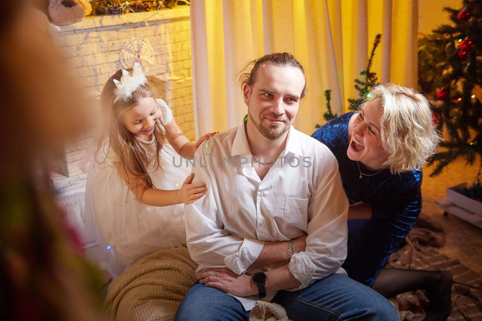 Family enjoys Christmas and New Year celebrations with a decorated tree, laughter, and joyful moments in their home.