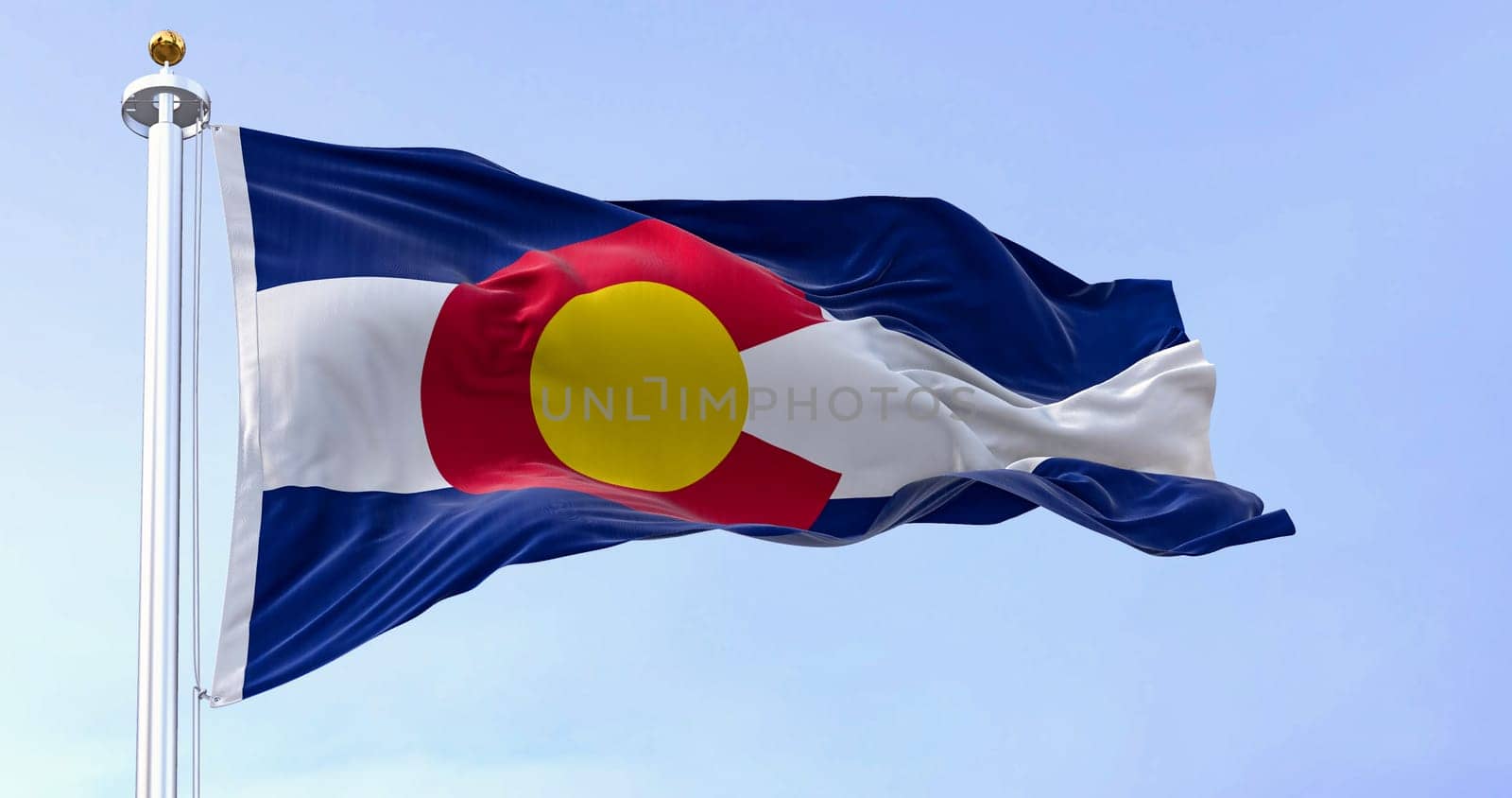 Colorado state flag waving in the wind on a clear day. Three blue, white, and blue stripes. Red C with gold disk on top. 3D illustration render. Fluttering fabric. Selective focus
