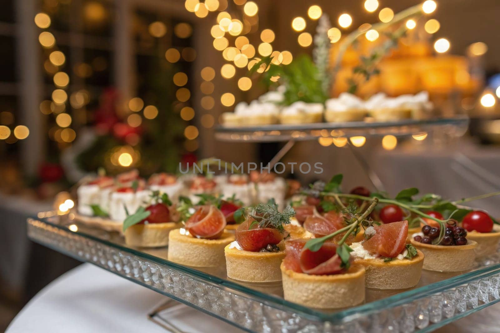 A beautiful display of assorted appetizers is presented on a glass platter at an evening event.