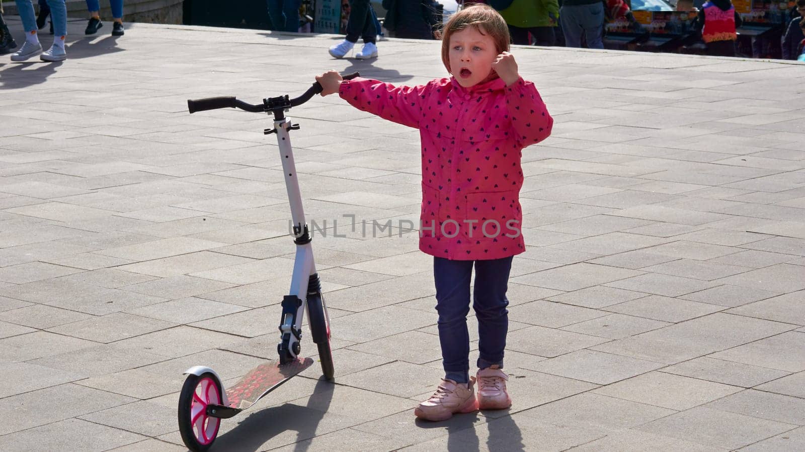 a light two wheeled open motor vehicle on which the driver sits over an enclosed engine with legs together