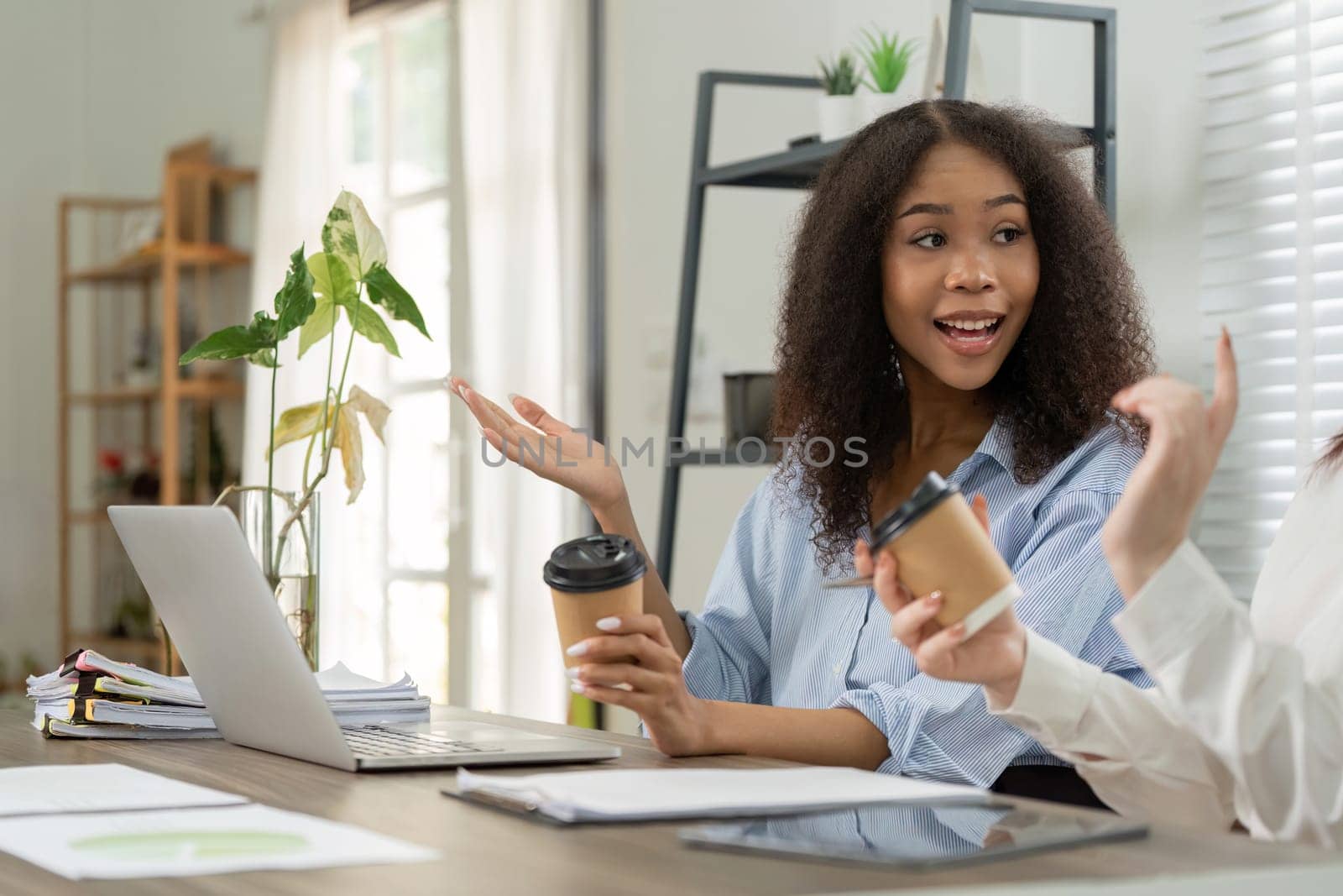 During their break, two coworkers discuss ongoing projects and exchange creative ideas, exemplifying collaboration in a relaxed setting.