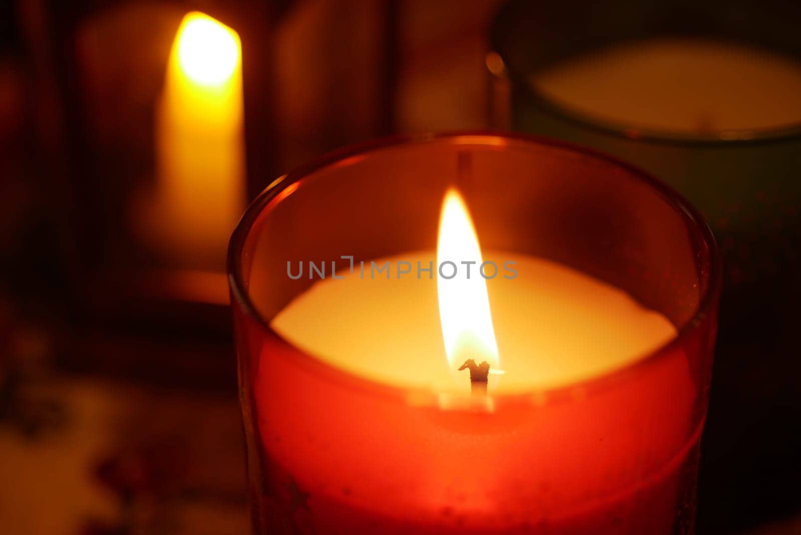 Candles cast a soft glow, creating a tranquil ambiance in a room.