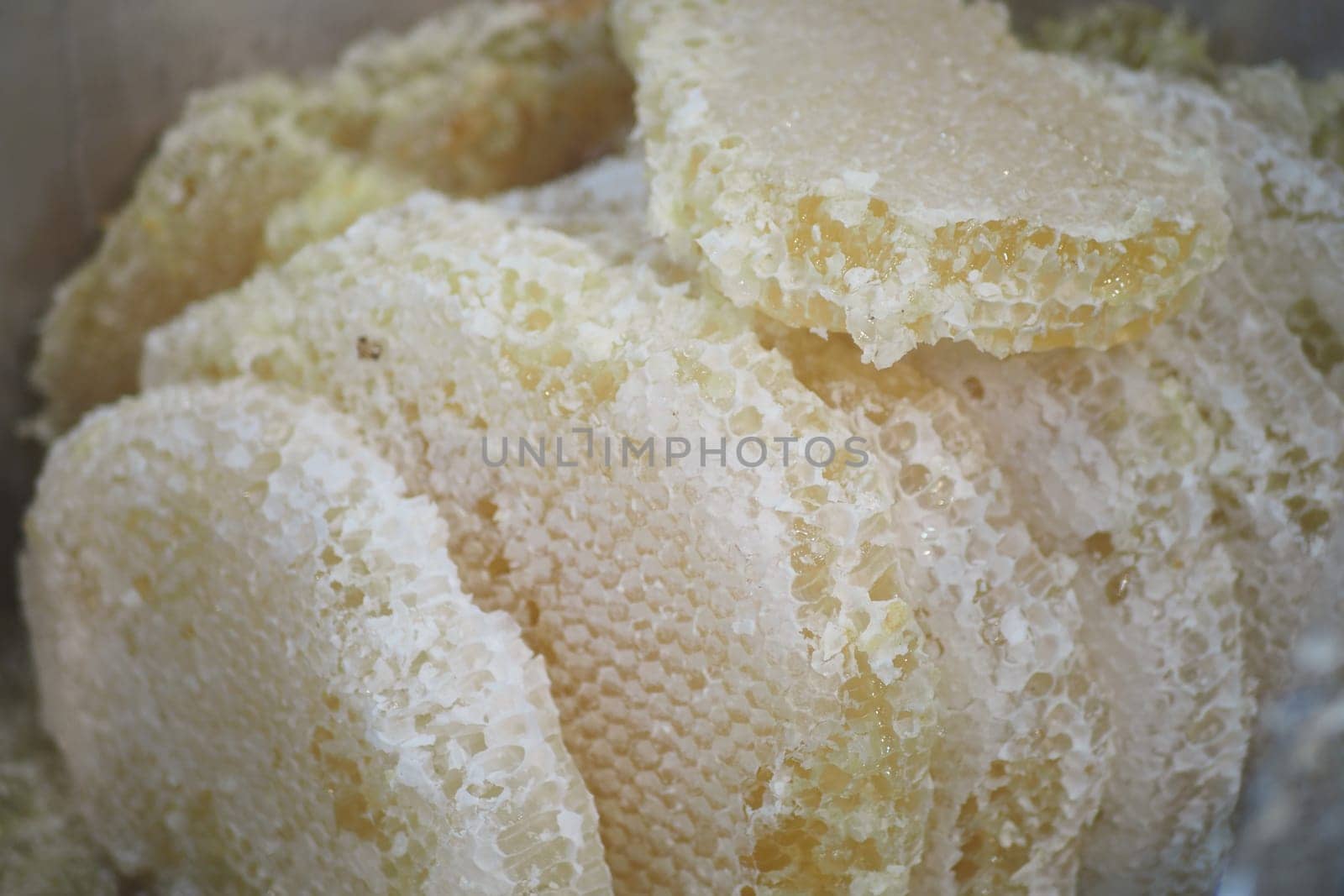 Natural honeycomb pieces displayed for sale at an open market setting.