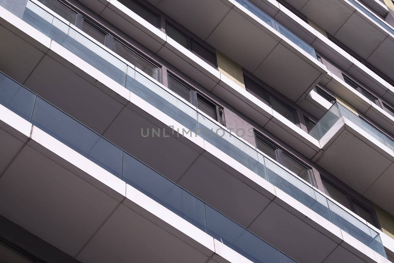 A contemporary residential structure with multiple levels and glass balconies.