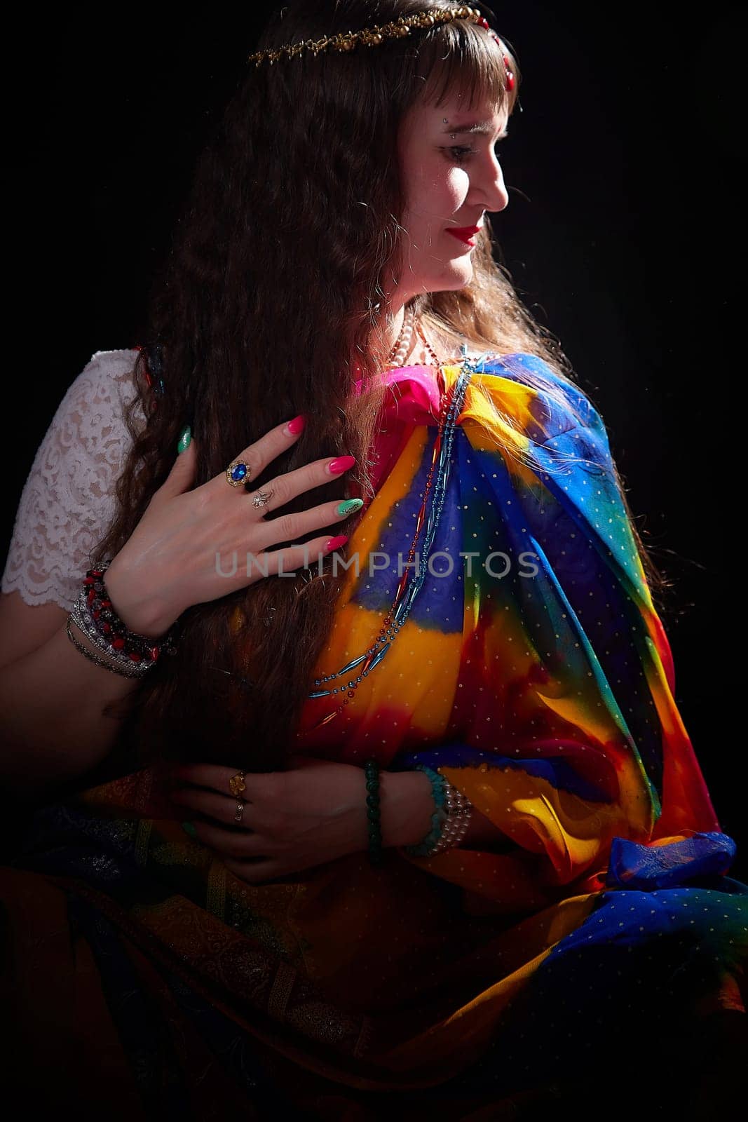 A mature blonde woman showcases a colorful sari while posing elegantly, capturing the essence of Indian fashion and lifestyle in a creative shoot.