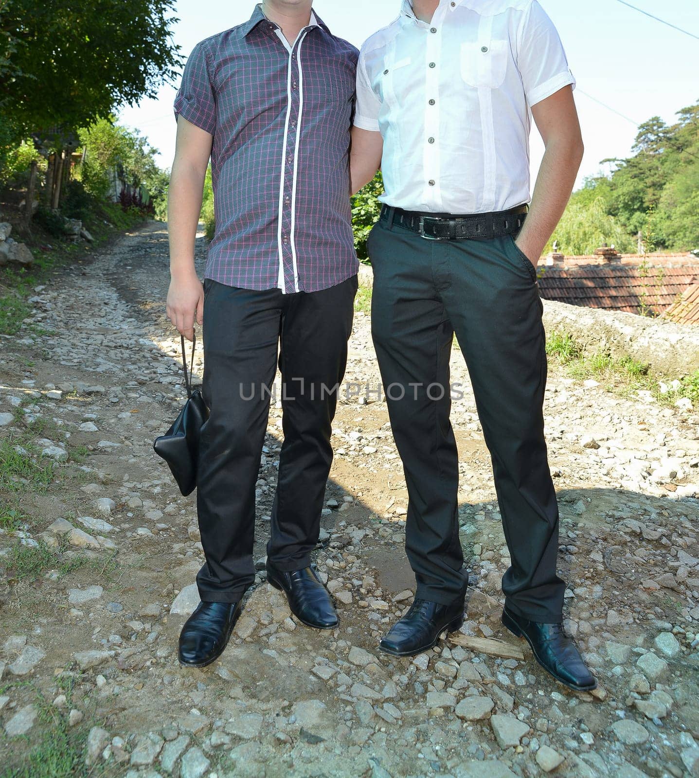 A group of people stand side by side, each wearing distinct formalwear, sharing in the spirit of the occasion
