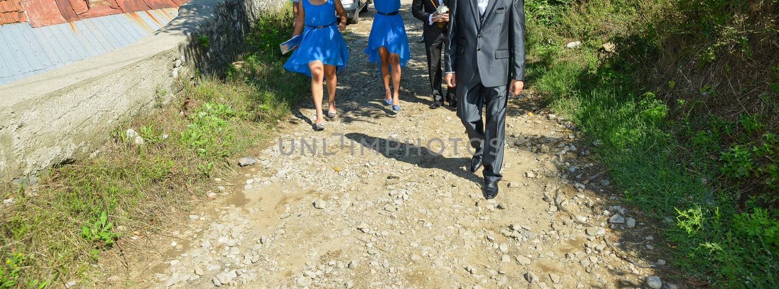A stylish gathering featuring vibrant blue dresses and formal shoes, capturing the essence of celebration.