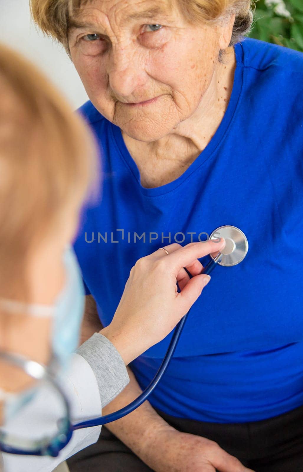 Elderly woman at a doctor appointment. Selective focus. People.