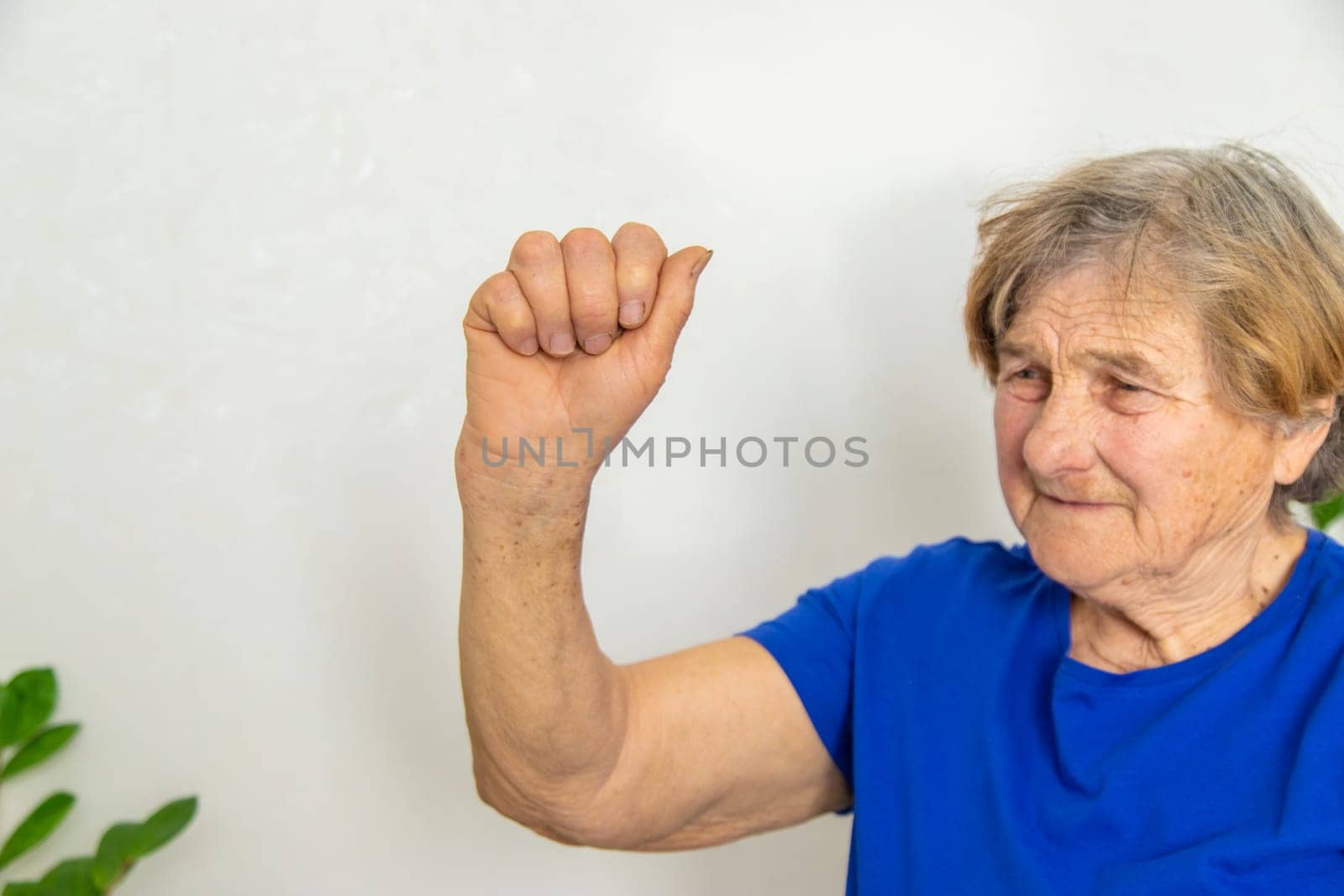 Old woman walking on the hand. Selective focus. people.