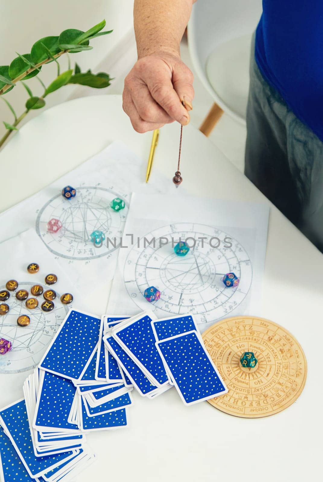 Pendulum fortune telling and astrology. Selective focus. people.