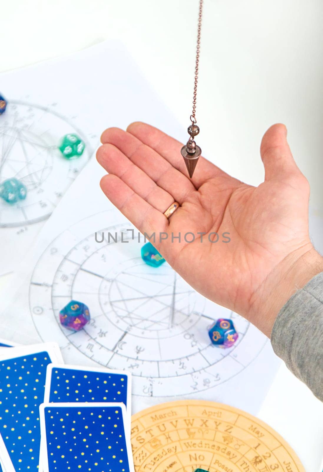 Pendulum fortune telling and astrology. Selective focus. people.