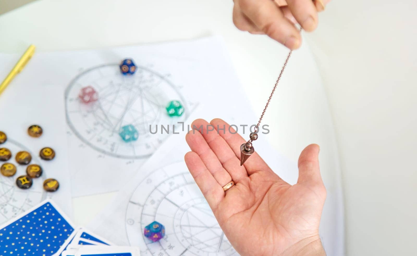 Pendulum fortune telling and astrology. Selective focus. people.