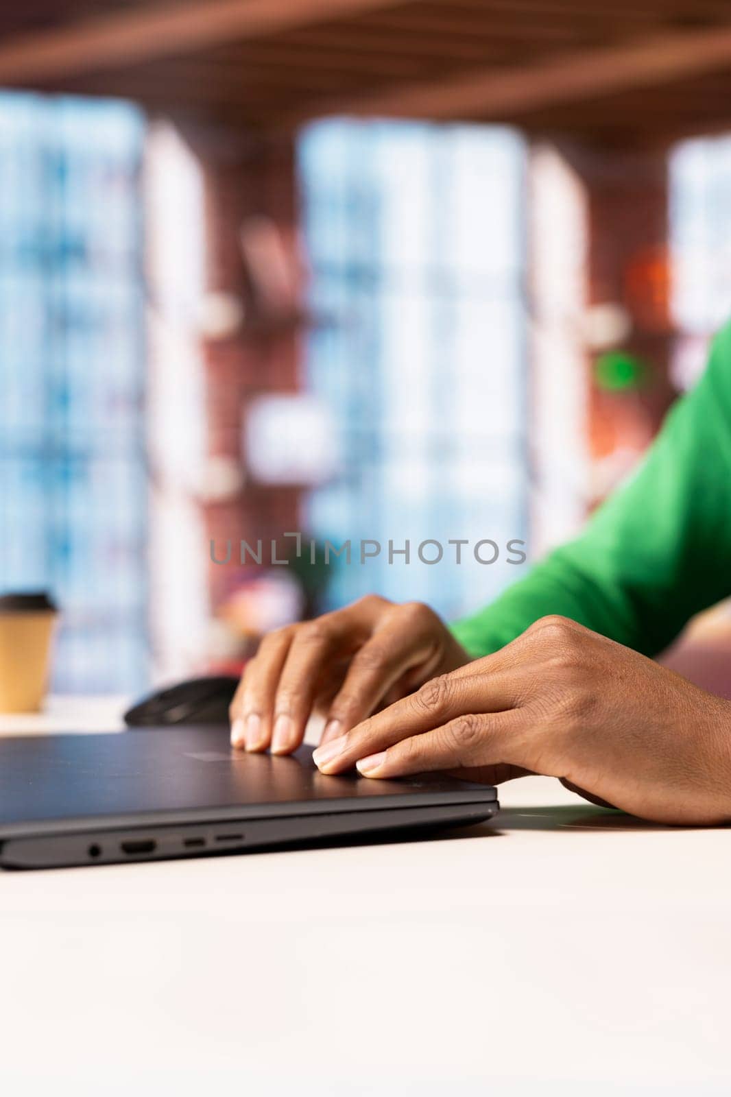 Remote employee at home office desk closing laptop after finishing compose social media posts for the day. Close up of social media manager ending job shift, preparing to leave apartment workspace