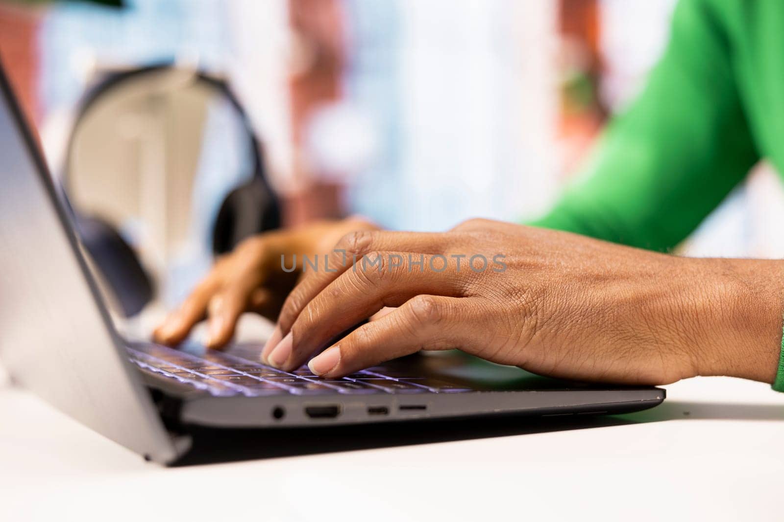 Freelancer at home office desk typing on laptop keyboard to compose social media posts, producing content. Close up of remote worker using notebook to monitor company social media engagement
