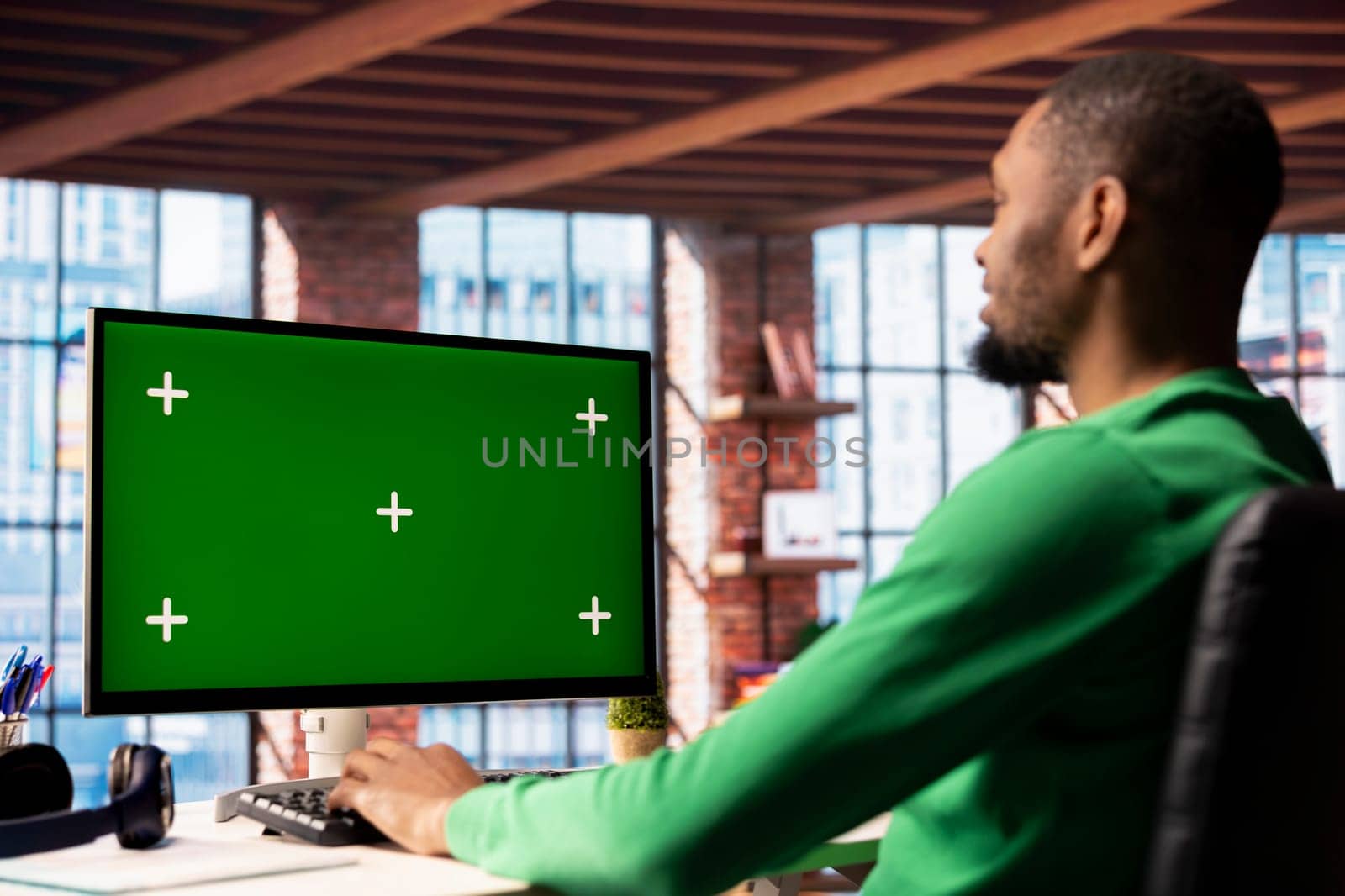 Man using isolated screen PC in home office to write emails. African american person typing on mockup computer keyboard, composing documents in order to deliver finalized project paperwork