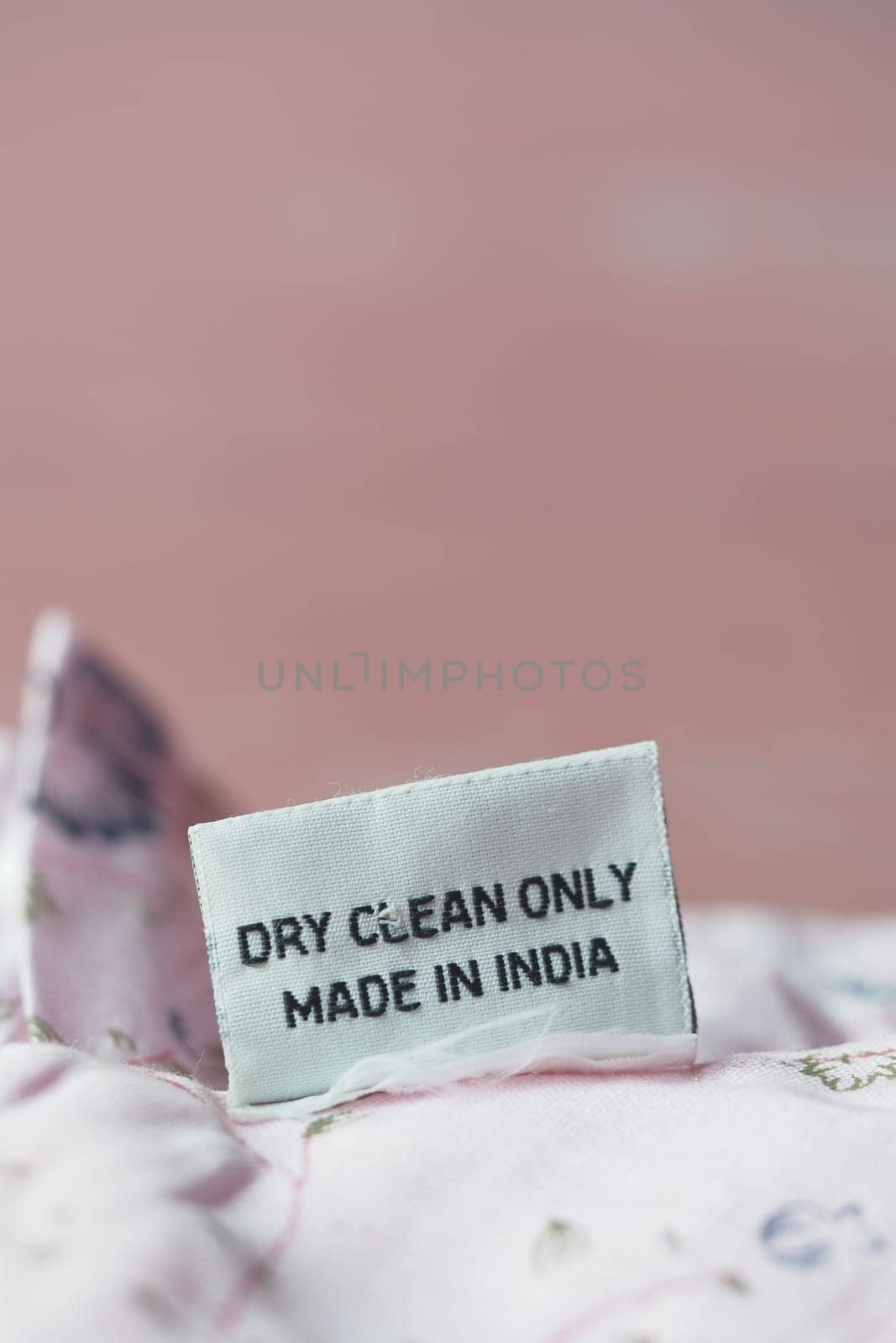 A clothing label indicates dry clean only instructions and origin in India.