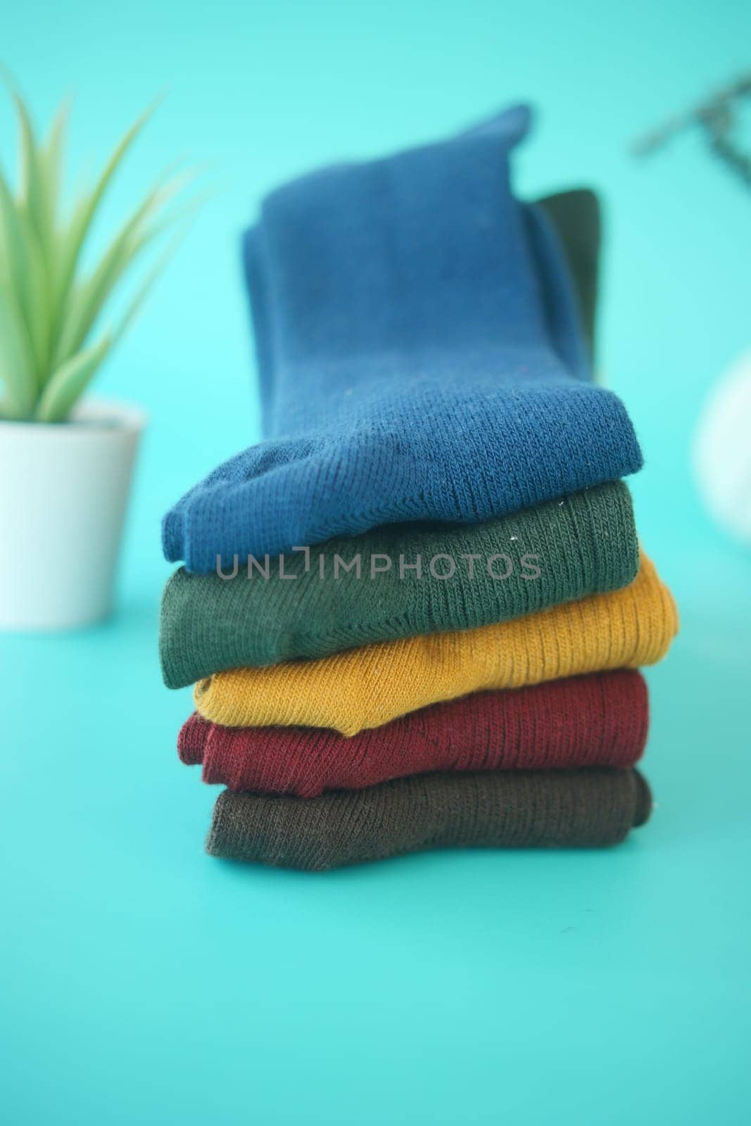 Vibrant socks stand out in bold colors on a blue backdrop.