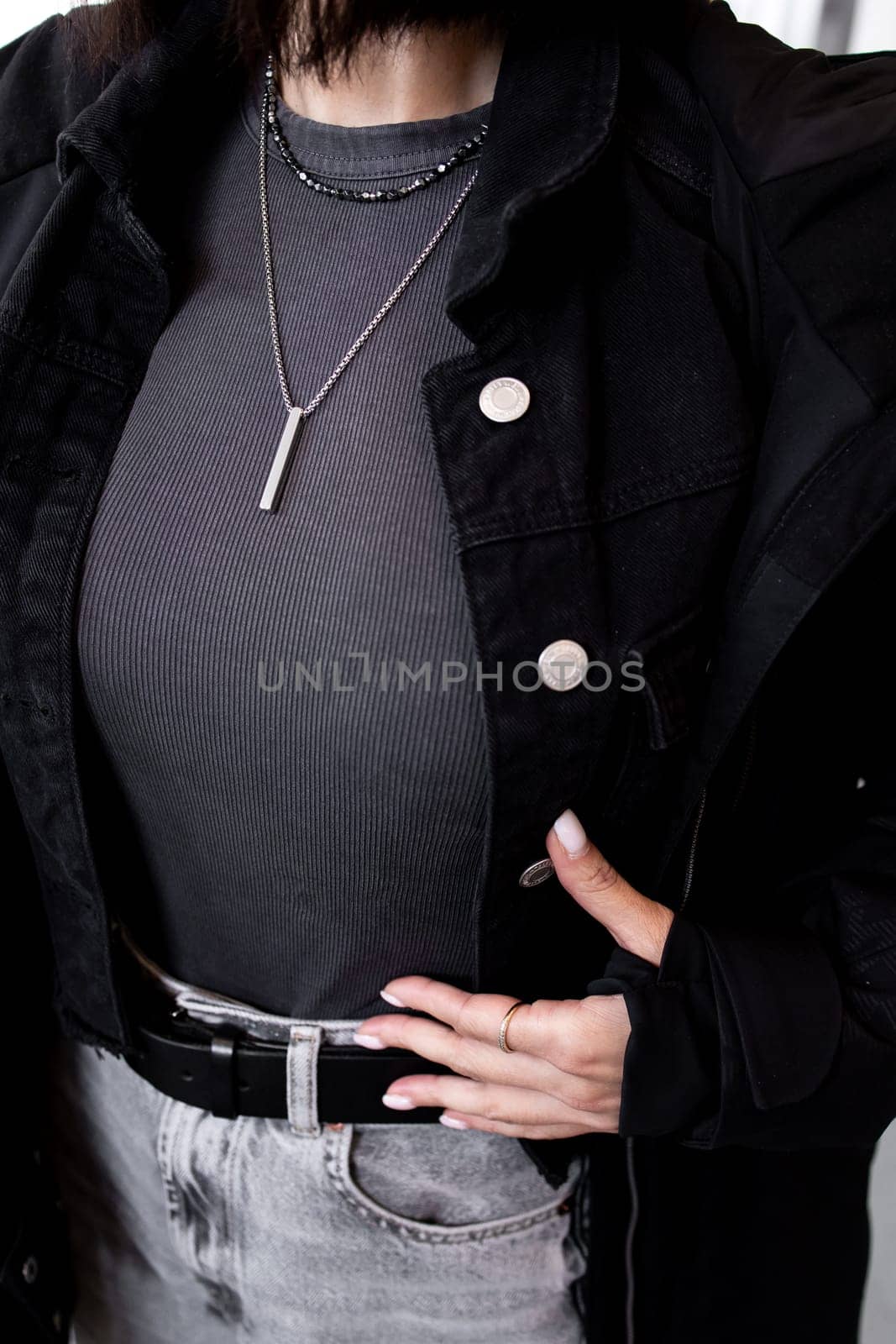 Fashionable female in black jacket and accessories.