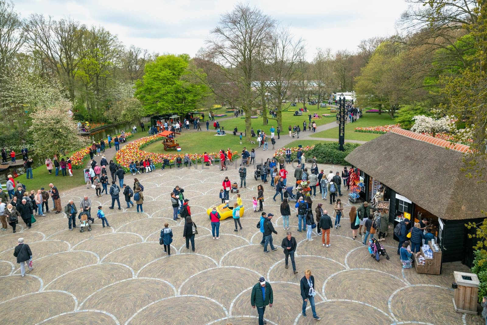 Lisse, Netherlands - April 17, 2019: Numerous people walk in a Keukenhof park View from above
