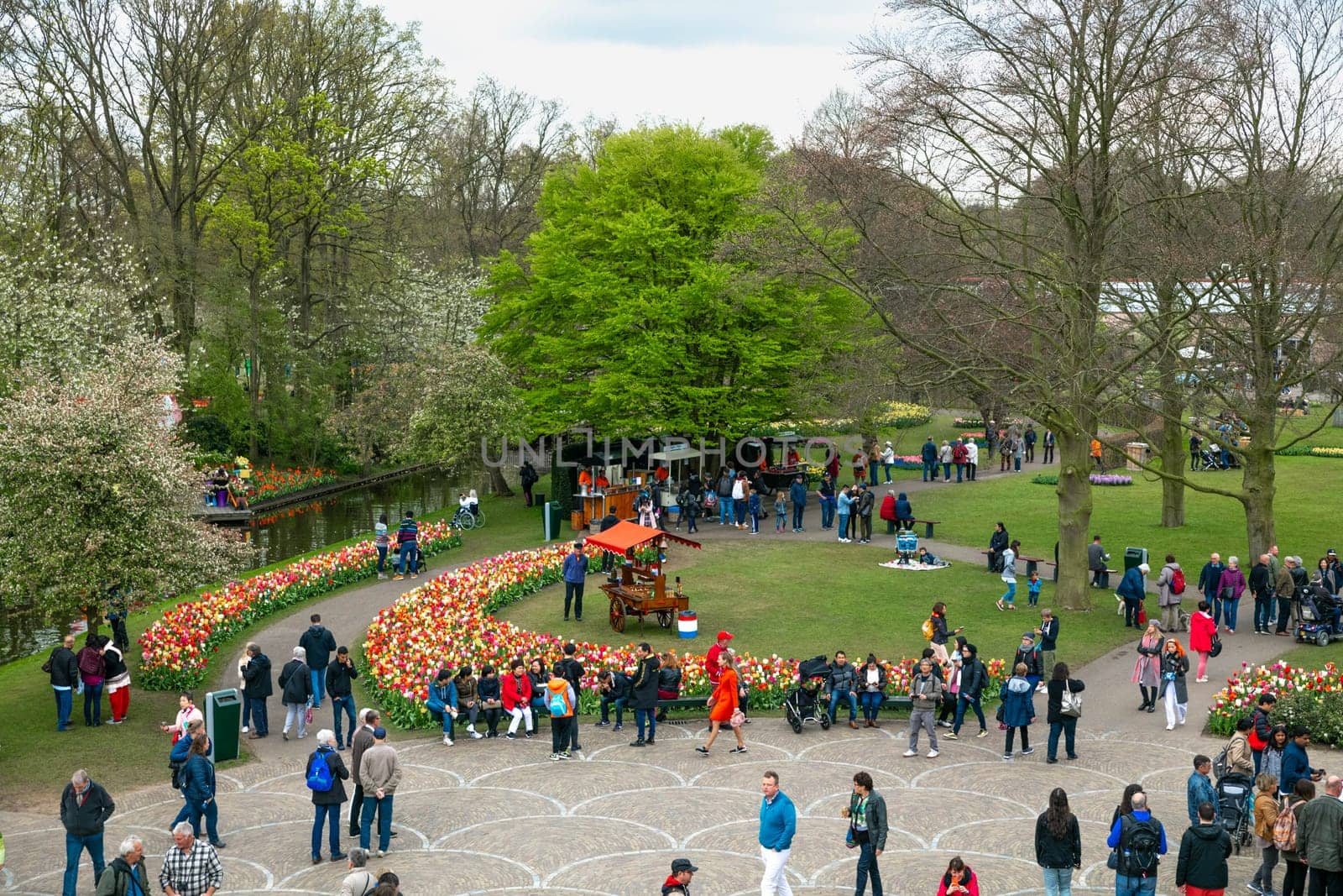 Lisse, Netherlands - April 17, 2019: Numerous people walk in a Keukenhof park View from above