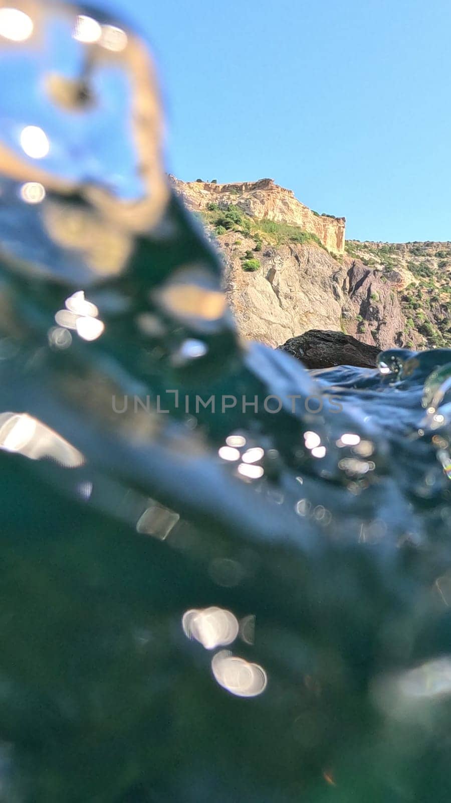 A body of water with a mountain in the background