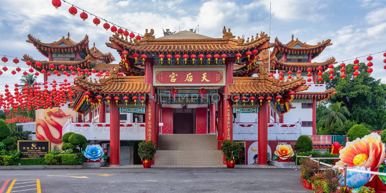 Thean Hou Temple, in Kuala Lumpur, Malaysia, showcases intricate architecture surrounded by bright red lanterns and colorful floral decorations