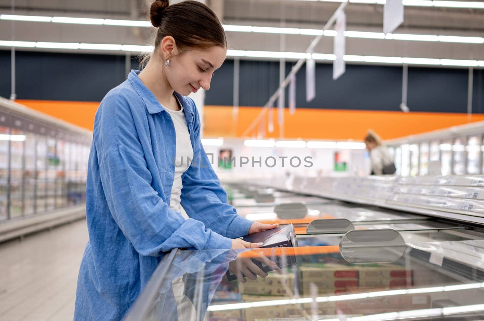 Girl Choosing Frozen Foods In The Supermarket