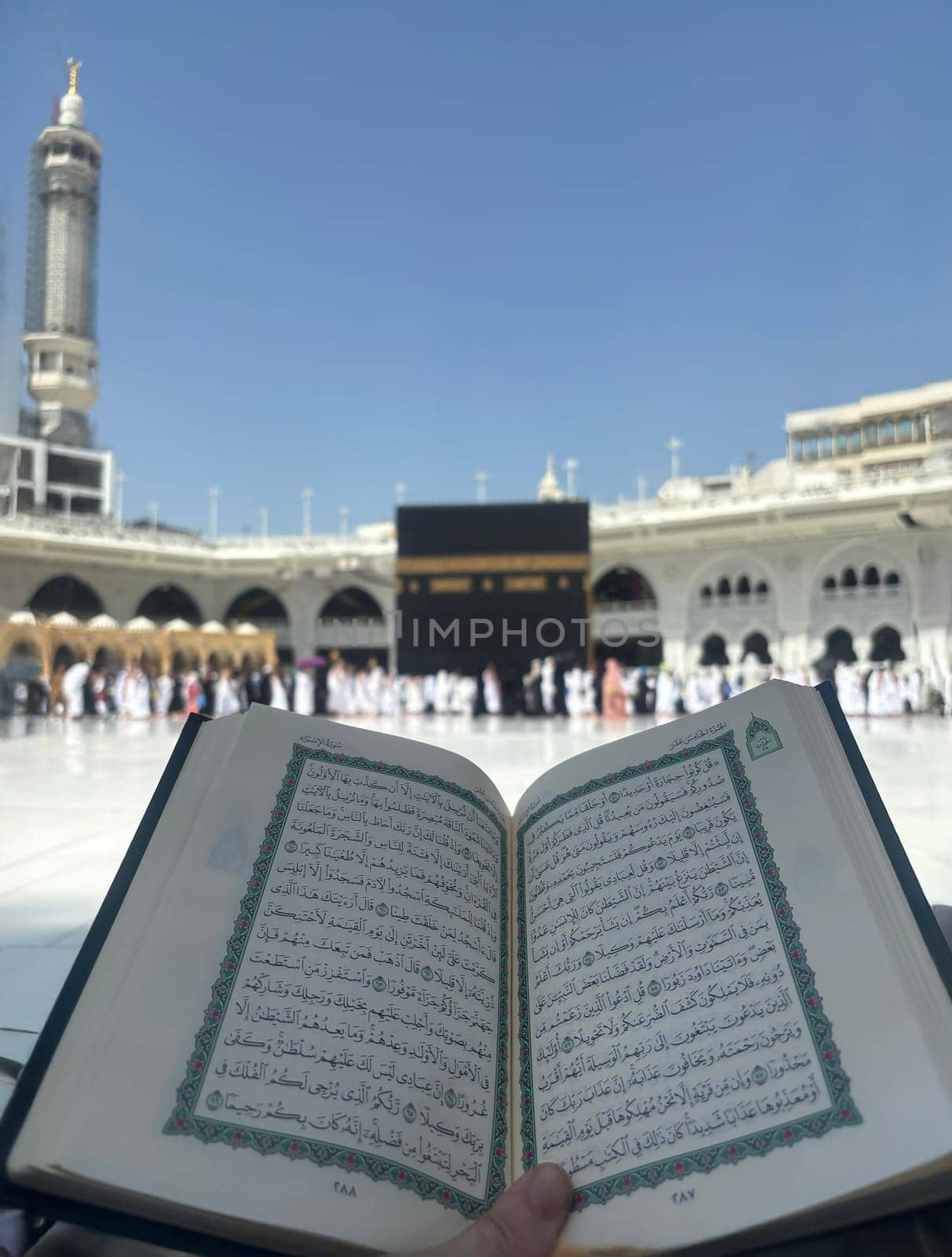 Mekkah, Saudia Arabia, 02 May 2024, A Quran reading in front of the Kaaba at Masjid al-Haram, Mecca, Saudi Arabia. Worshippers perform Tawaf around the sacred site under a clear blue sky, symbolizing faith and devotion in Islam.