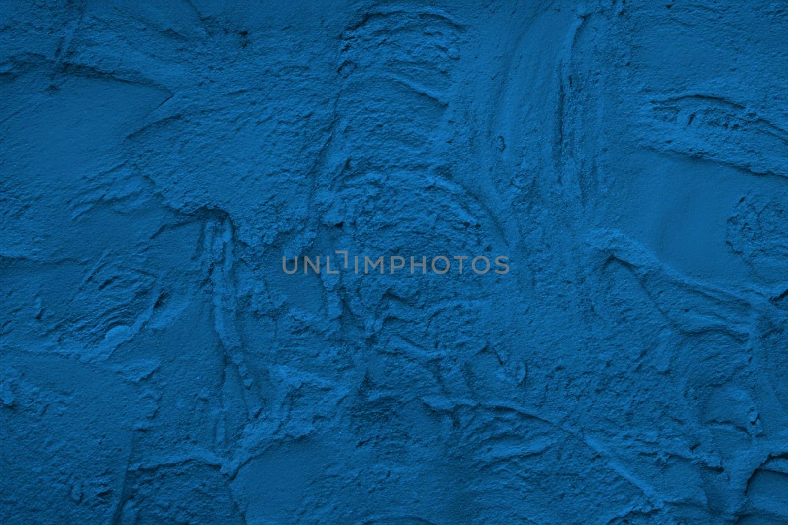 Abstract decorative dark blue plaster wall background
