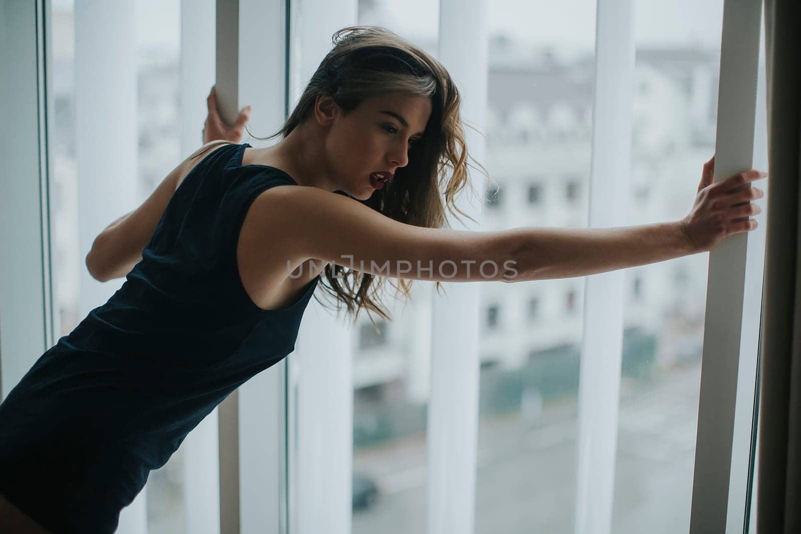 Pretty young woman by the window in the room