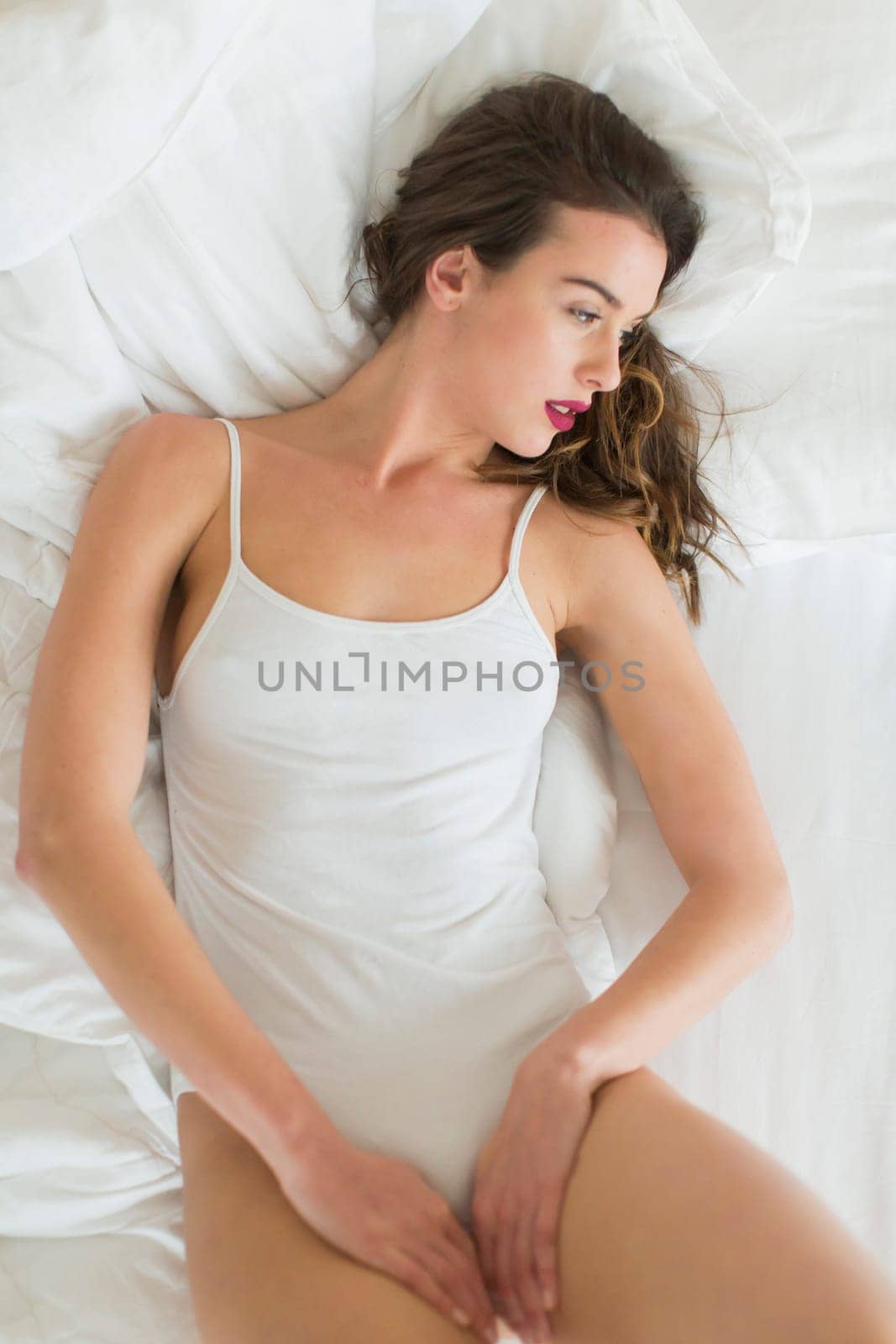 Attractive young woman lying on the bed