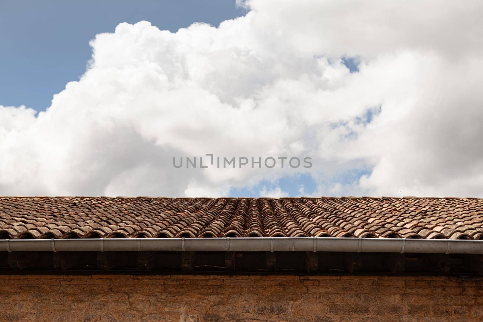 Cloudy sky above a tiled roof