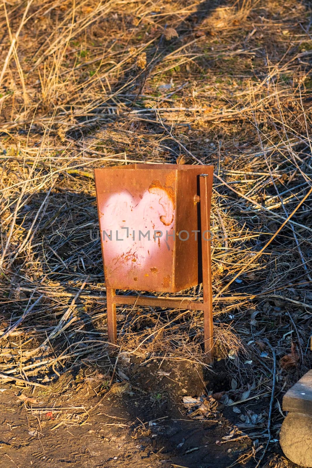 Outdoor trash bin with heart painted on it