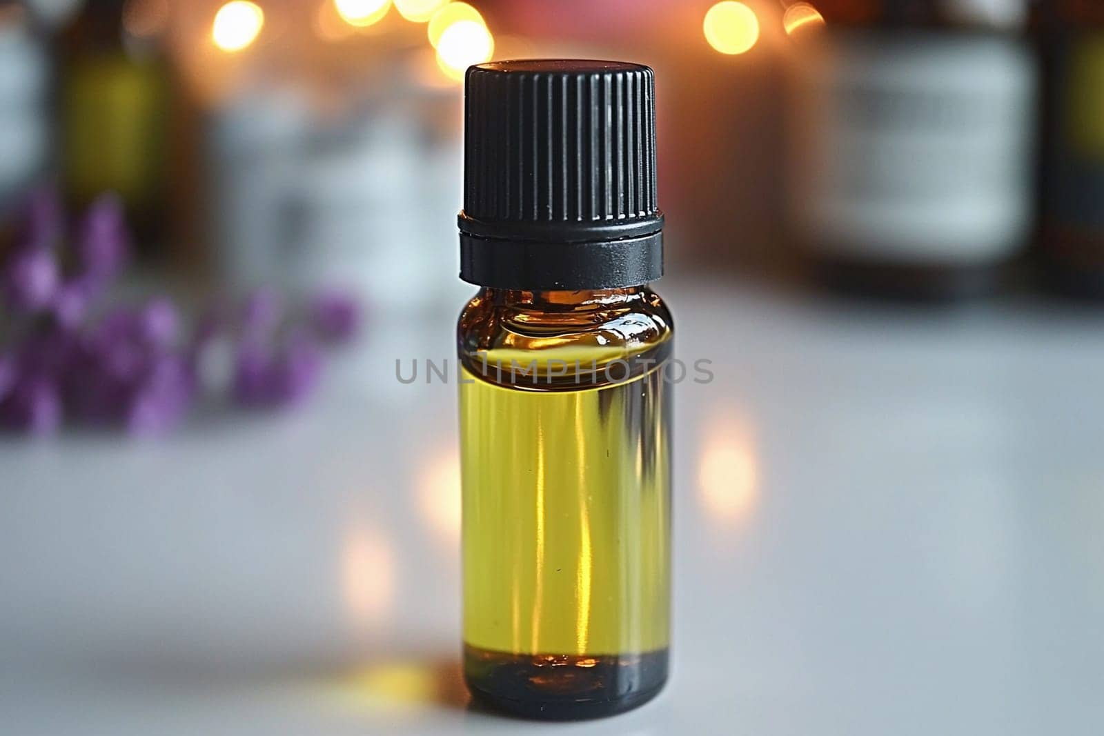 A bottle of essential oil filled with golden liquid sits on a table, illuminated by soft, warm bokeh lights in the background, creating a tranquil ambiance.