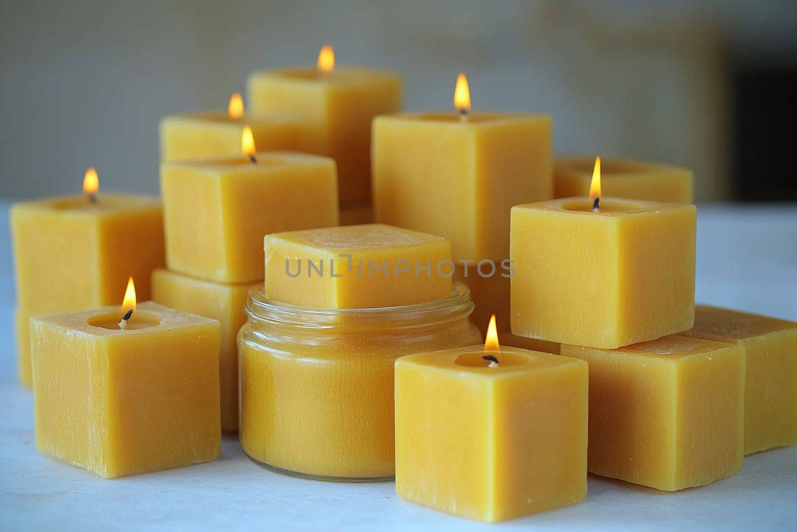 A collection of beeswax candles in various sizes radiates a warm glow in a bright room, creating a soothing and inviting ambiance for relaxation or meditation.