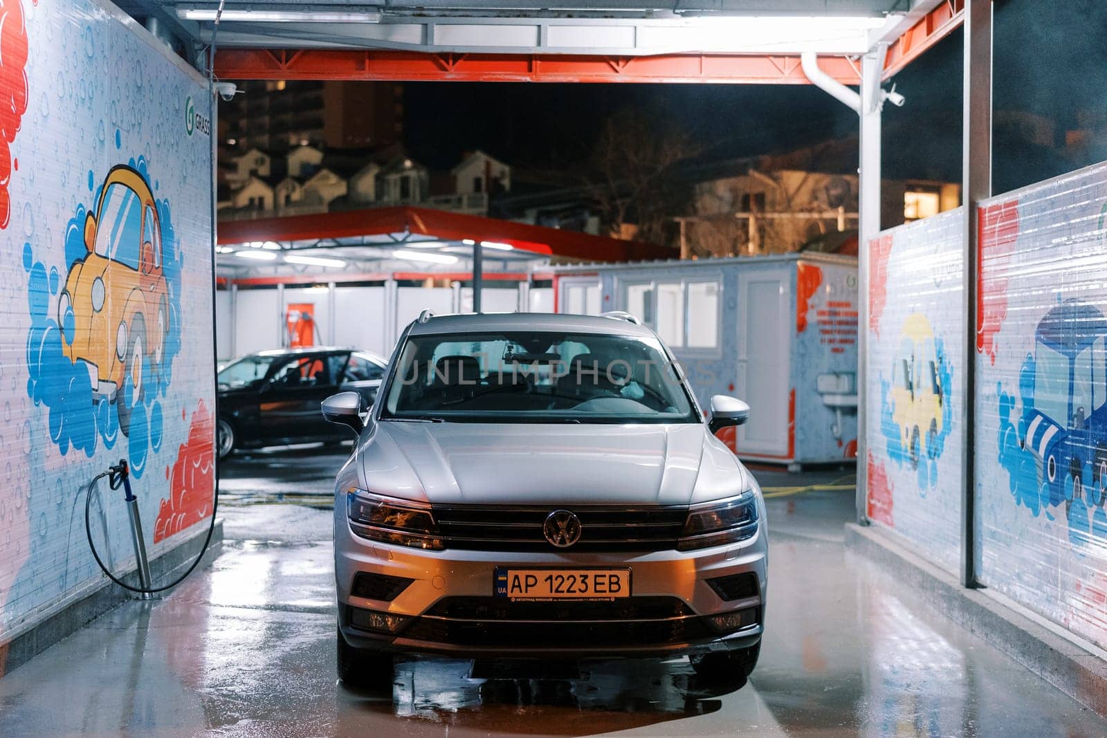 Wet car stands at a self-service car wash. High quality photo