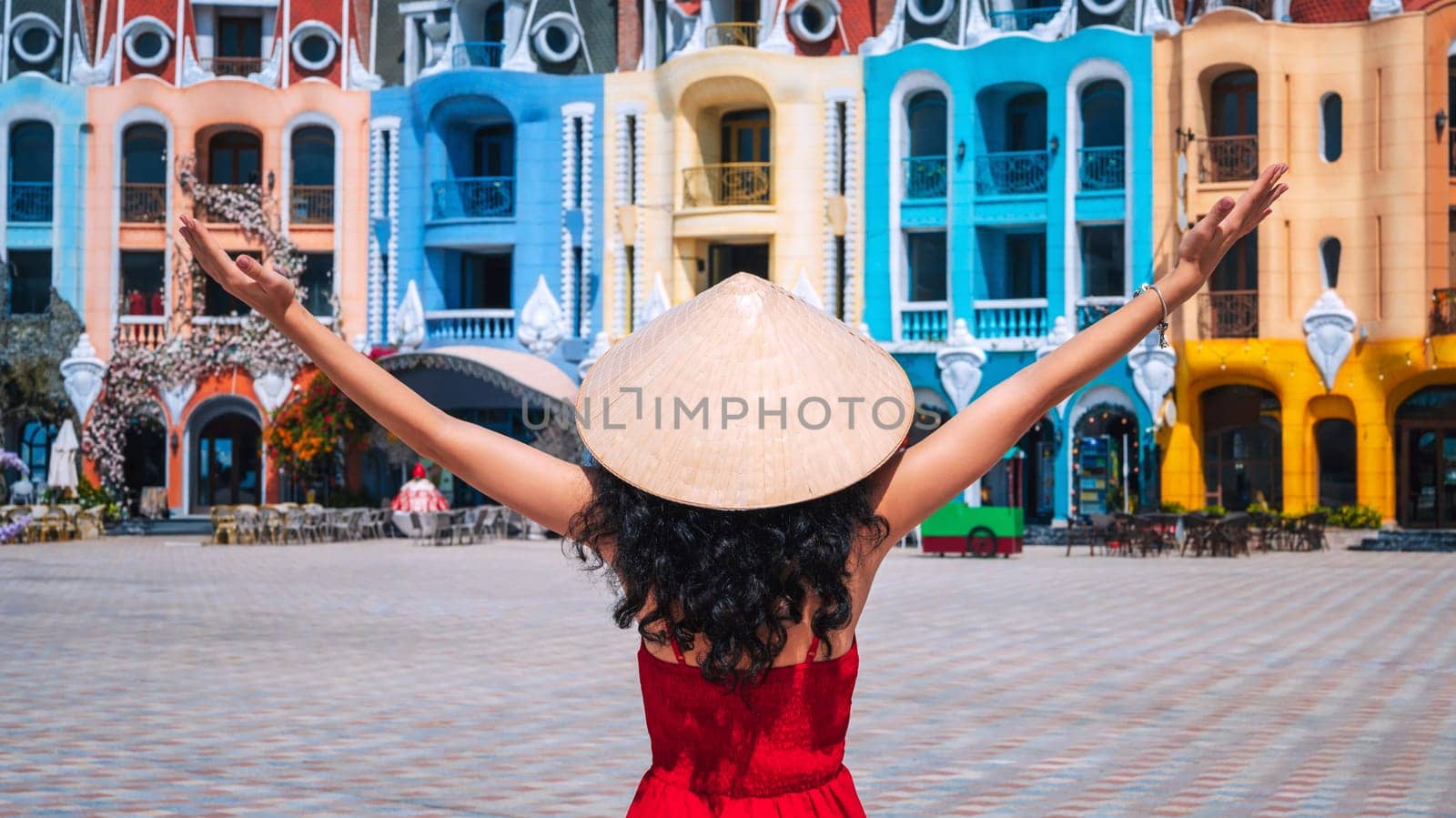 young woman tourist traveler in a Vietnamese hat Non La on Vinpearl Island at VinWonders Amusement Park in Nha Trang at summer vacation in Asia. Travel and tourism in Vietnam