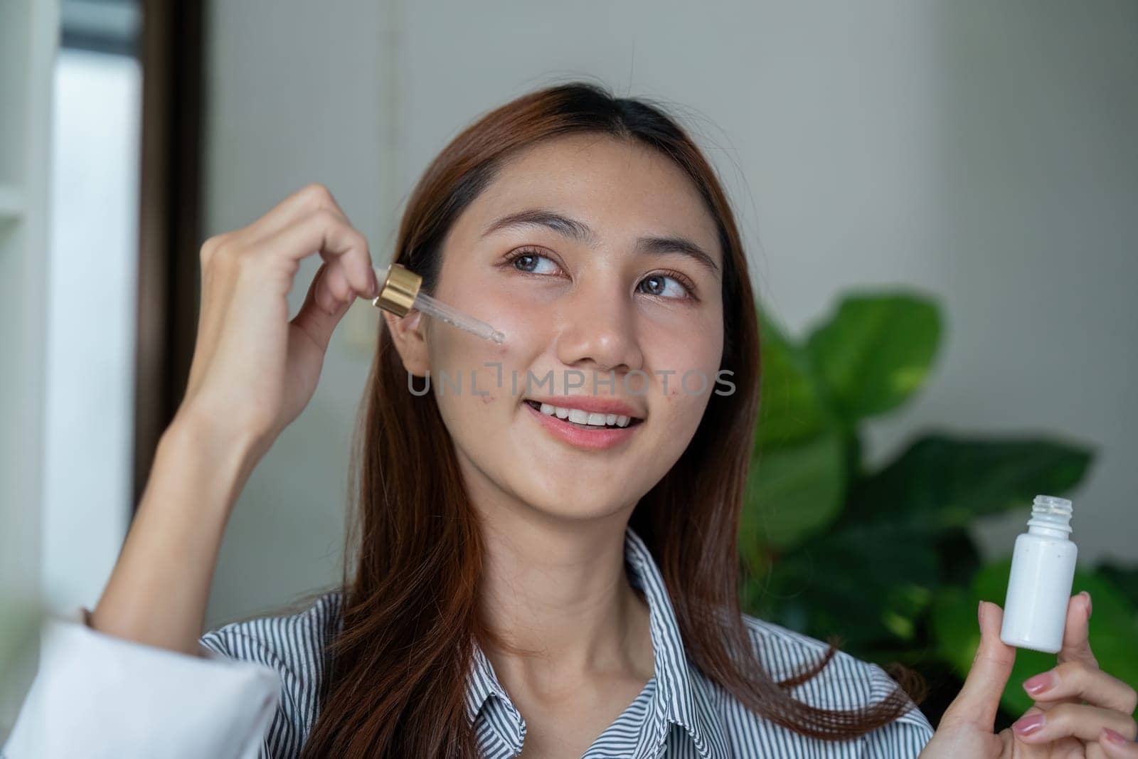 The woman holds a dropper and smiles while applying the serum to her cheek, highlighting her commitment to skincare and beauty. This image embodies self-confidence and care.