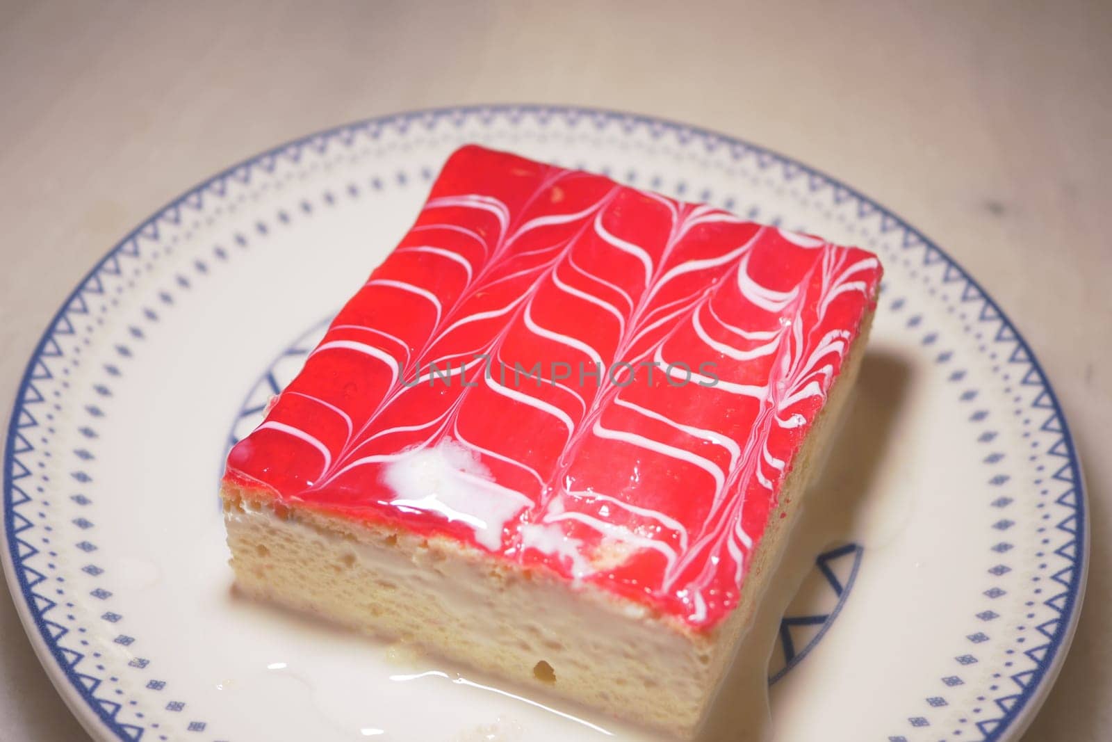 A delightful dessert showcases a colorful jelly topping on creamy base.