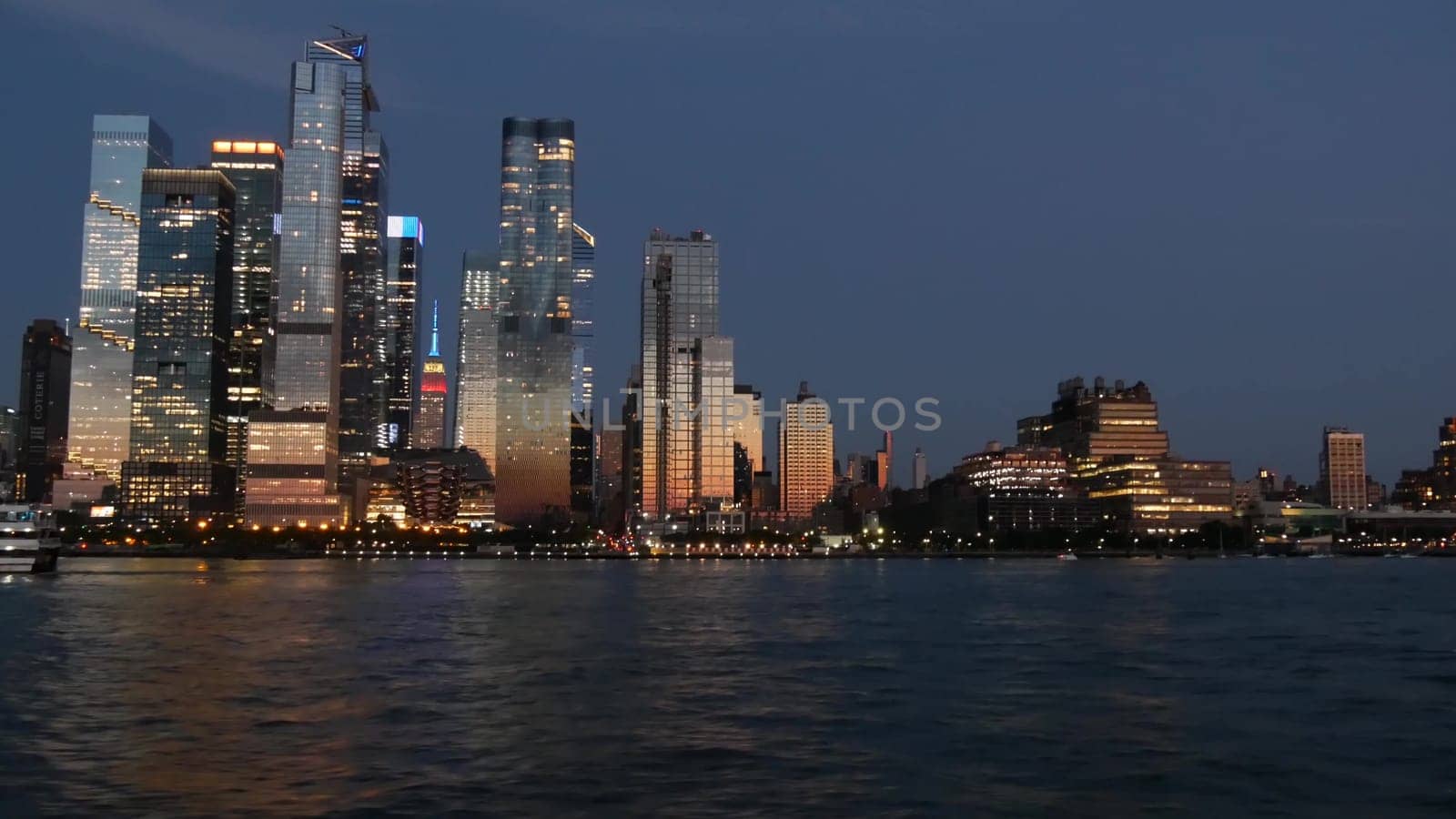 New York City, United States - 4 Sept 2023: Manhattan Midtown skyline from river ferry boat. Hudson Yards skyscrapers from ferryboat. Waterfront panorama riverfront architecture. Empire State Building