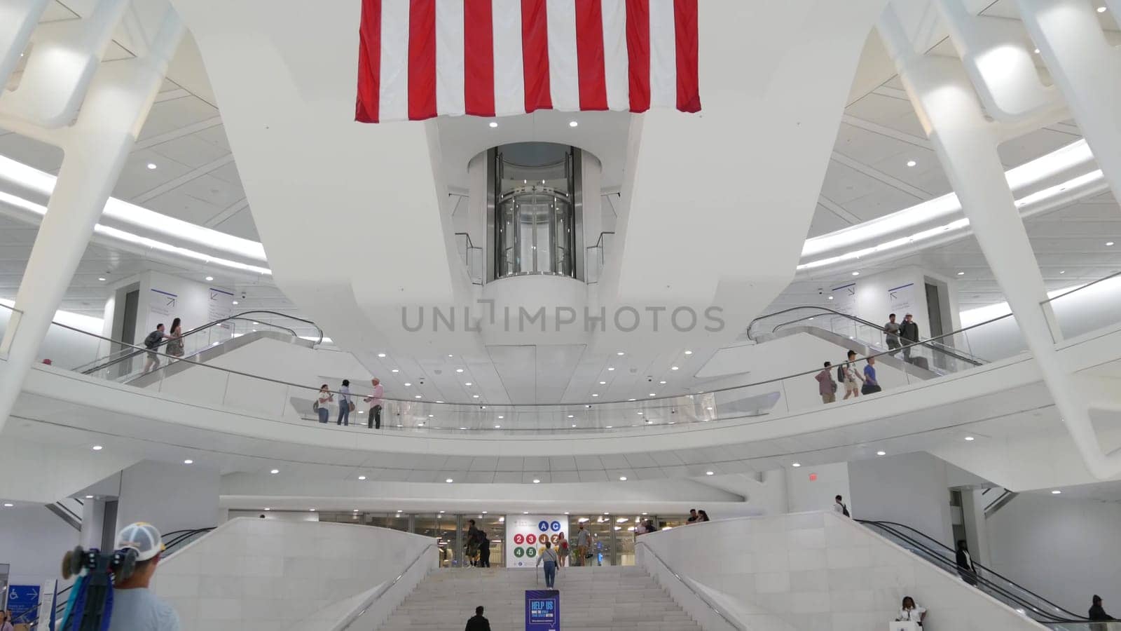 New York City, United States - 10 Sept 2023: World Trade Center Oculus architecture. Manhattan Downtown Financial District, USA. September 11 remembrance, memorial american flag. Patriot day. People.