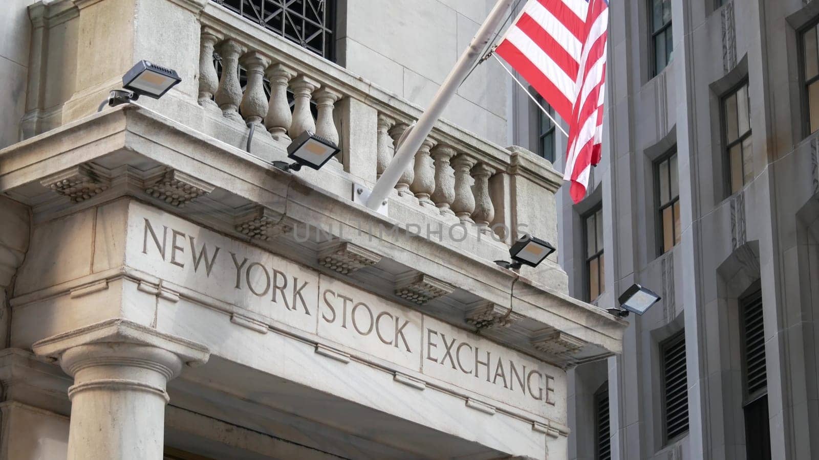 New York City, United States - 4 Sept 2023: Lower Manhattan Downtown Financial District urban architecture. American Flag. Wall street Stock Exchange building, USA Stock Market trading.