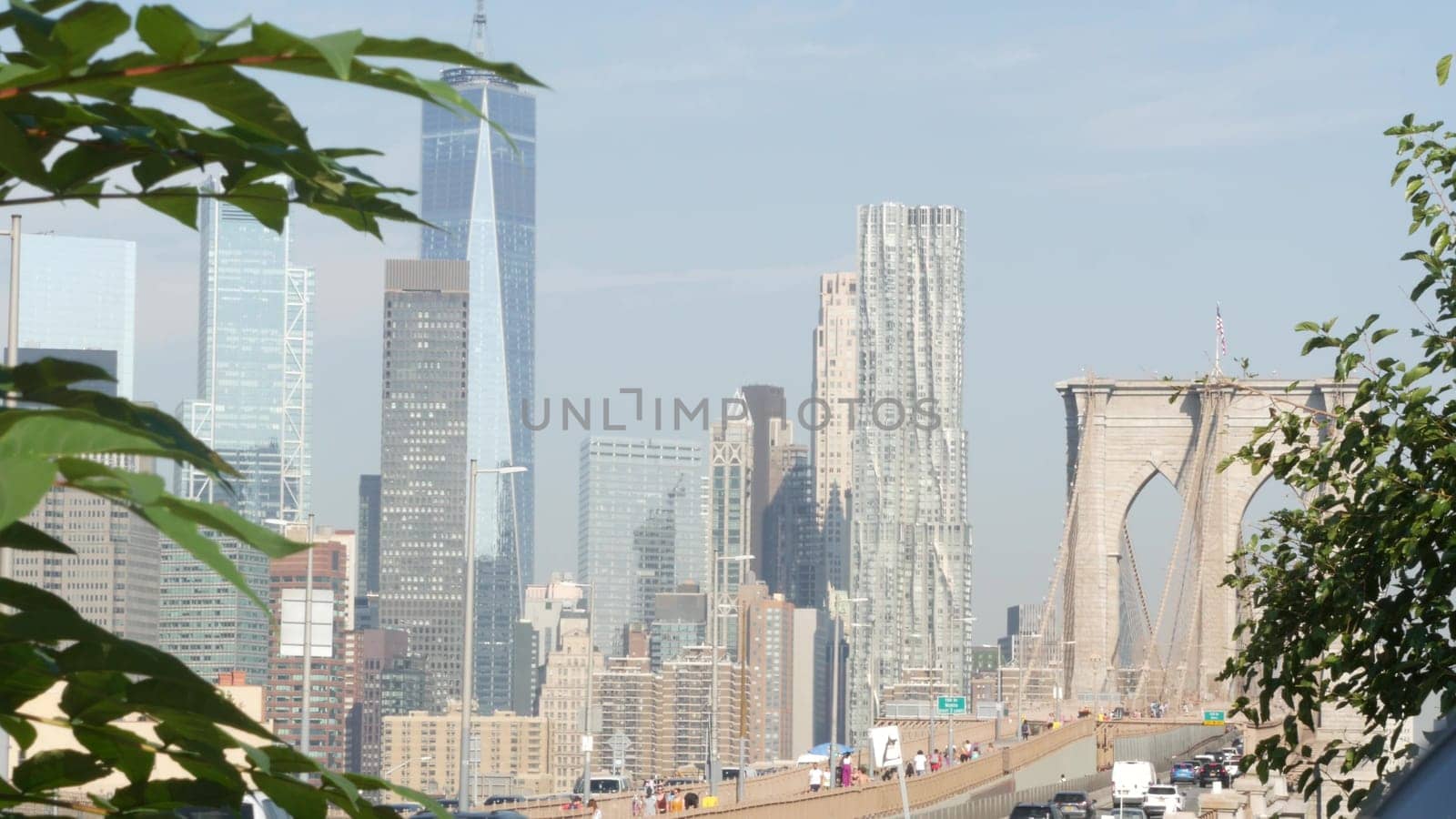 New York City, United States - 3 Sept 2023: Cars on Brooklyn Bridge from Manhattan downtown. Financial district skyline cityscape. Road traffic, people, architecture. World Trade Center skyscraper.